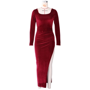 Macro shot of burgundy velvet dress fabric featuring elegant waist pleats and high slit