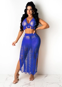 Detail of blue crochet knit beach set with cutout halter top and side slit maxi skirt