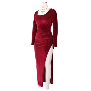 Detailed view of the burgundy velvet dress featuring vertical ribbed texture and side rushing