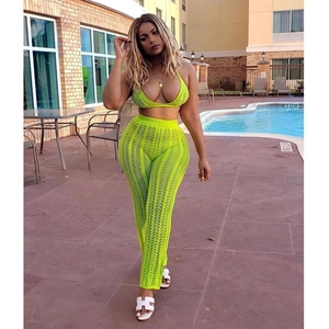 Detail of neon green crochet knit bikini top and high-waisted sheer striped pants set