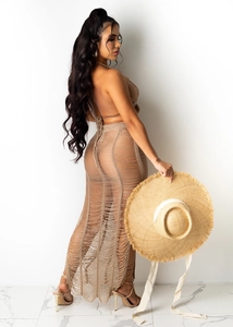 Detail of crochet knit beach set featuring halter backless top and hollow out maxi skirt