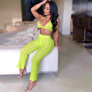 Women's two-piece neon green crochet set featuring deep V-neck halter top and high waist pants