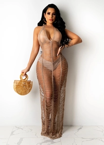 Detailed close-up of tan crochet knit beach dress with sexy halter neck and sheer fringes