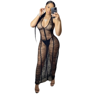Close-up of black mesh knit beach dress featuring ripped cut-out texture and halter neck