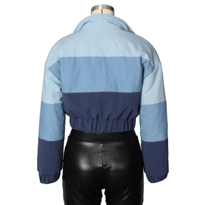 Detail view of the tricolor patchwork cotton jacket with elastic hem and dropped shoulders
