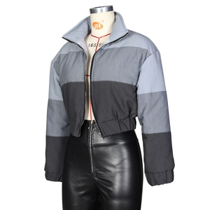 Detail of gradient grey patchwork puffer jacket with high collar and metal zipper