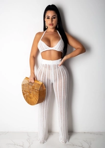 Close-up of white crochet hollow out knit set with intricate mesh texture detail