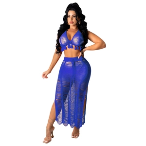 Detail of royal blue knit beach set featuring tassel hem and hollow out stripe texture