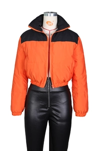 Detail of orange and black contrast puffer jacket with a high stand collar and zipper