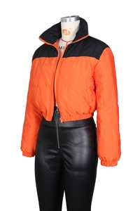 Detail of high neck contrast puffer jacket in bright orange and black glossy fabric