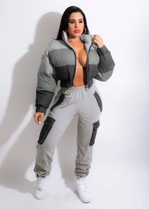 Detail of color-block cropped jacket and cargo pants showing knitted fabric and texture