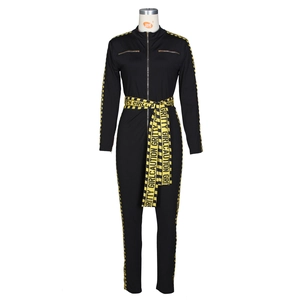 Women's black long sleeve jumpsuit with yellow Gritty Girl caution tape detail and zipper
