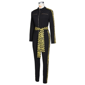Close-up of gritty girl caution tape straps and zipper on black slim fit jumpsuit