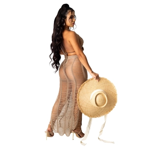 Detail of beige crochet knit two-piece beach set featuring side slit and open back design