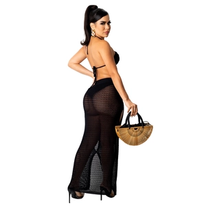 Detail of black knit crochet beach cover-up set featuring fishtail skirt and hollow texture
