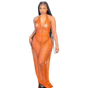 Detail of orange crochet knit maxi dress with sheer hollow out pattern and fringe hem