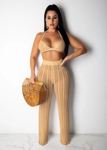 Detail of crochet knit texture on apricot two-piece set with halter top and trousers
