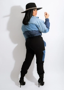 Detail of color-block denim patchwork jacket with elastic hem and cargo pocket jeans