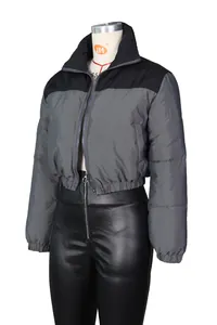 Detail of color-block puffer jacket featuring stand collar and elastic hemline