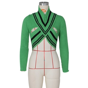 Close-up of green ribbed knit bolero featuring V-neck and contrasting black striped edges