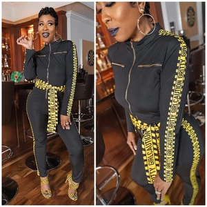 Sexy black long sleeve jumpsuit featuring yellow gritty girl caution tape print details