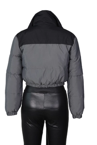 Detail view of two-tone cropped puffer jacket with elastic hem and high collar design