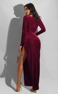 Detail of burgundy ribbed velvet texture on high slit long sleeve evening dress