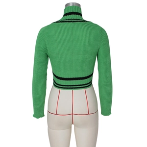 Detail of green knit sweater showing high collar and black stripe accents on hem