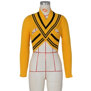 Detail of yellow ribbed knit sweater with criss-cross V-neck and black stripes