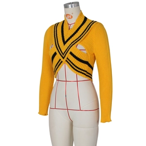 Detail of yellow ribbed knit shrug showing V-neck crossover and black contrast stripes