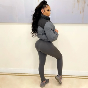 Detail of a women's dark grey cropped puffer jacket and matching high-waisted leggings