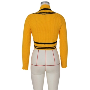 Detailed knit texture of yellow turtleneck sweater with black stripes on the back side