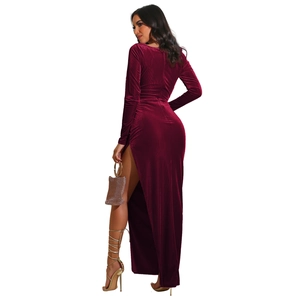 Detail view of burgundy velvet evening dress showing side slit and fabric texture