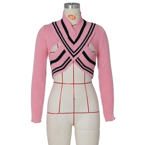 Close-up of pink V-neck knit sweater showing black and white striped trim and soft texture