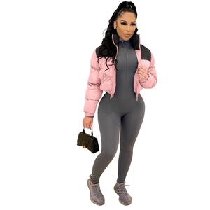 Close-up of pink and black color block puffer jacket with textured crocodile skin handbag