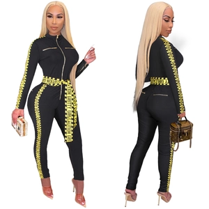 Slim fit black long sleeve jumpsuit with yellow Caution Gritty Girl side tape detailing