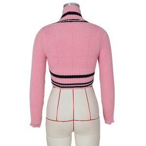 Detail of pink cropped knit sweater featuring black stripes on high collar and back hem