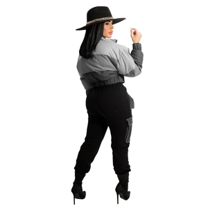 Side view of woman in cropped gray puffer jacket and black cargo pants with stiletto boots