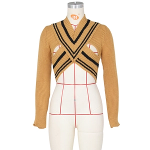 Macro detail of camel knitted bolero with contrasting black V-shaped crossover stripes