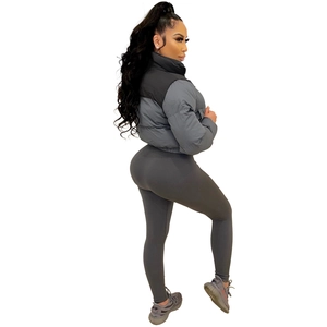 Detail of a grey quilted puffer jacket and high-waisted ribbed leggings on a model