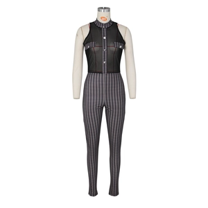 Detail of sheer black mesh sleeveless jumpsuit with houndstooth pattern and silver buttons