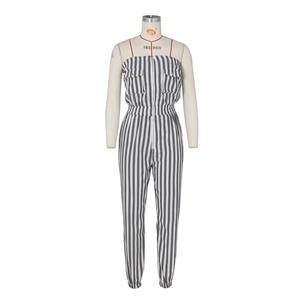 Detail view of the black and white striped jumpsuit featuring a front zipper and flap pockets