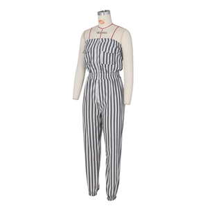 Detail of striped tube top jumpsuit with front zipper and cargo pockets on white background