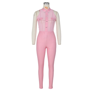 Detail of pink sleeveless romper featuring houndstooth trim and silver decorative buttons