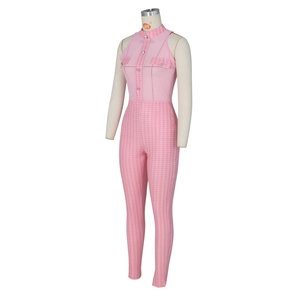Detail view of pink houndstooth jumpsuit with stand collar and decorative metal buttons