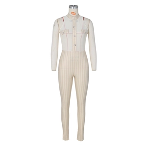 Detail of slim-fit sleeveless jumpsuit featuring houndstooth pattern and metal buttons