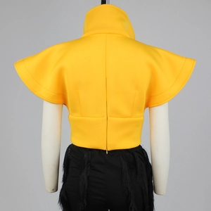 Detail of a yellow high-neck vest with sculptural flutter sleeves and back zipper closure
