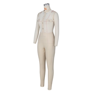 Detailed close-up of sleeveless mesh jumpsuit featuring houndstooth pattern and silver buttons