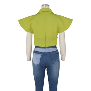 Rear view of grass green crop top featuring ruffled wing sleeves and a stand collar