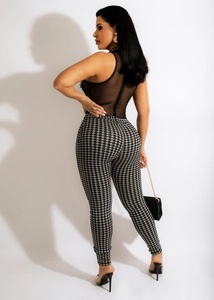 Detail of sheer mesh sleeveless top and houndstooth pattern slim fit jumpsuit